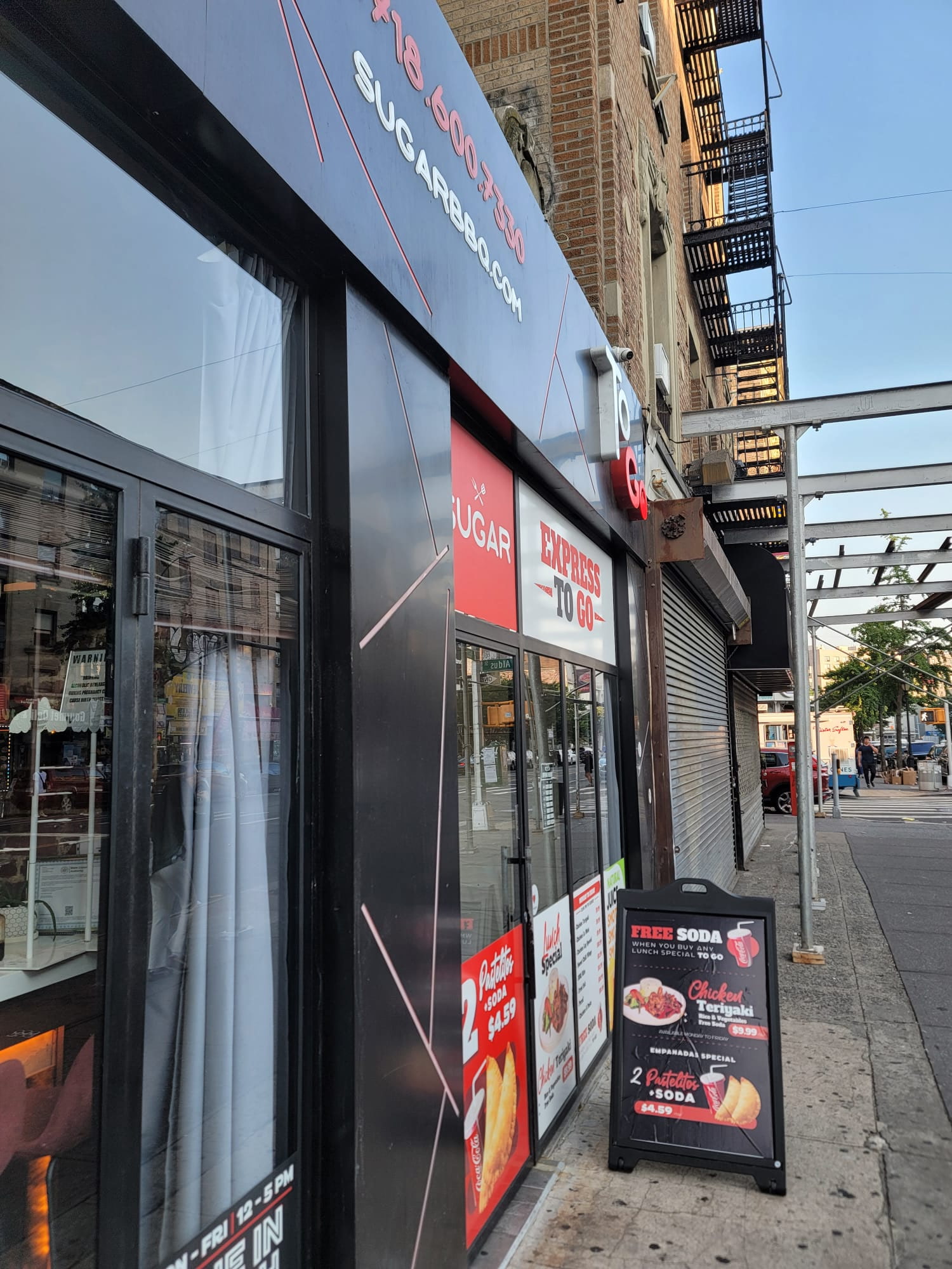 Sugar BBQ storefront side view — illuminated channel letters and vinyl, Bronx NY